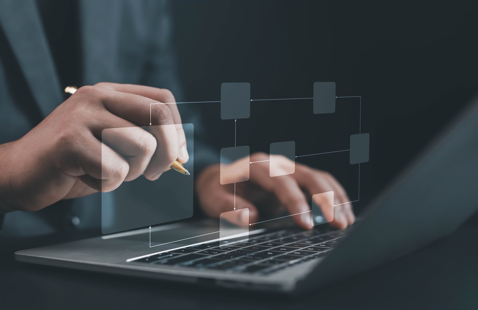 Business process management concept showing person using laptop and pen to design digital flowchart interface, representing workflow optimization, data structure, and corporate planning strategy.